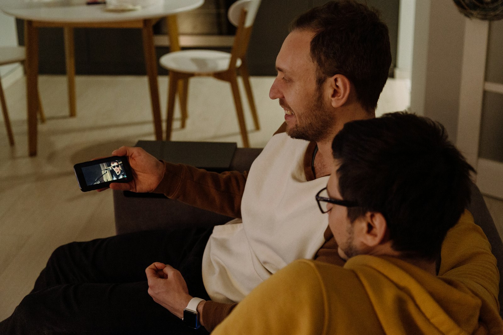 Two friends watching a video on a phone