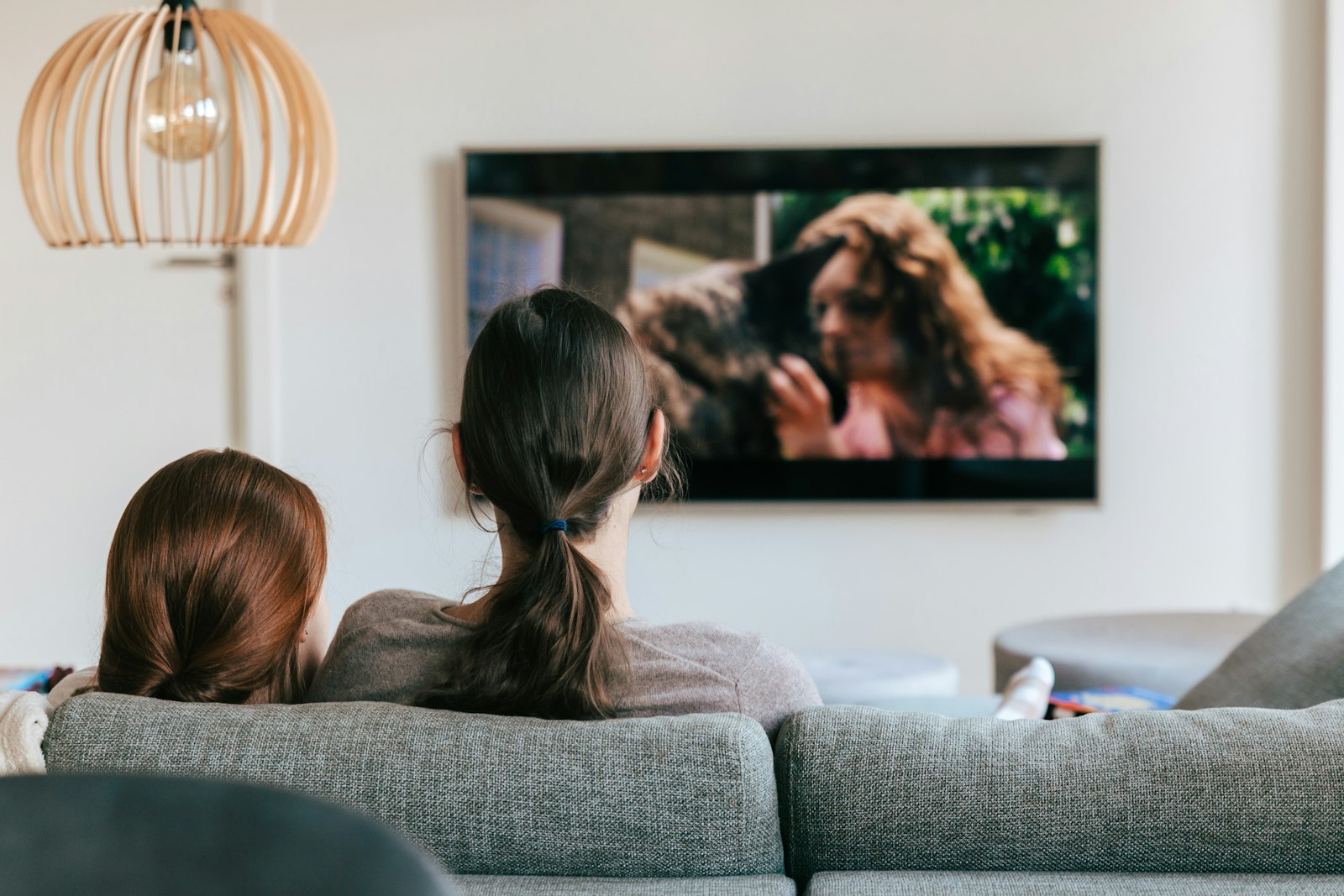 Two people watching TV from a couch